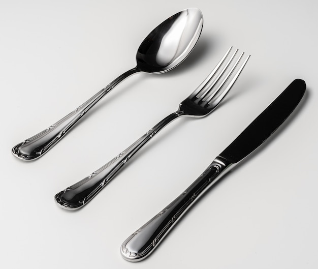 Spoon, fork and knife on a white background