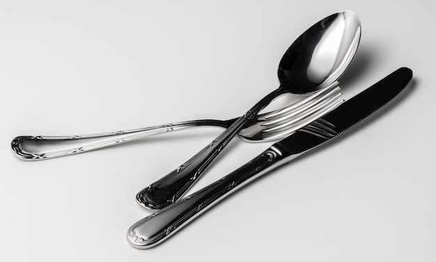 Spoon, fork and knife on a white