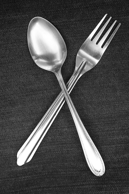 Spoon and fork placed on blue and white handkerchiefs