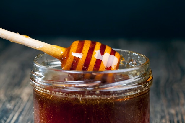 A spoon for honey together with high-quality bee honey