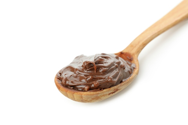 Spoon with chocolate paste isolated on white background