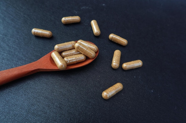 Photo a spoon with pills on it and a spoon with a spoon that says pill