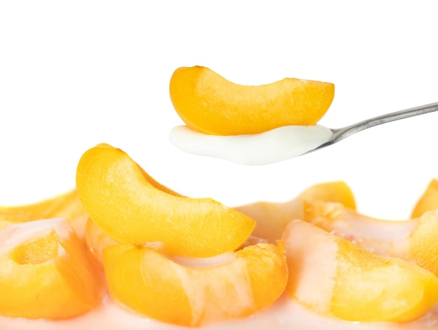 A spoonful of peaches and cream with a spoonful of yogurt.