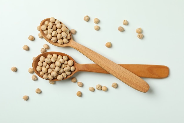 Spoons with fresh chickpea on white