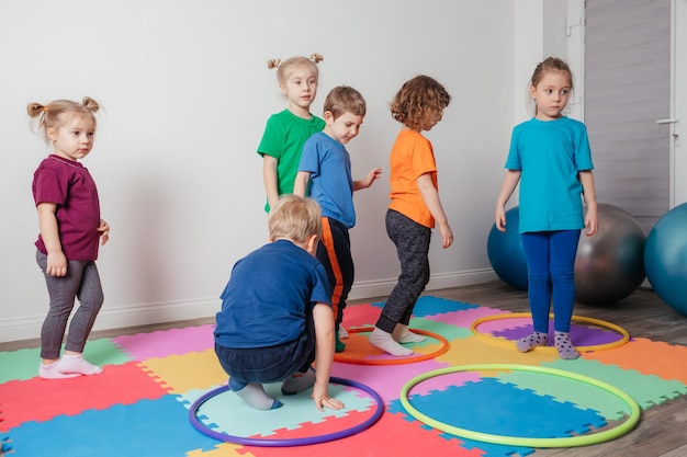 Sport activities with hula hoops at kindergarten