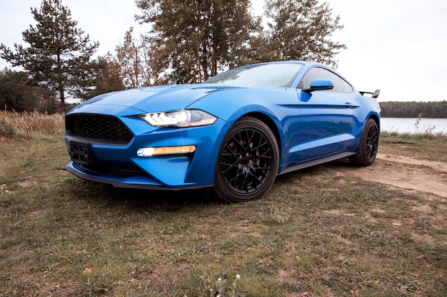 Sport car of blue color on a background of nature