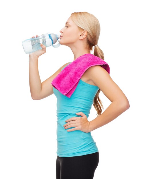 sport, excercise and healthcare - sporty woman with pink towel and water bottle