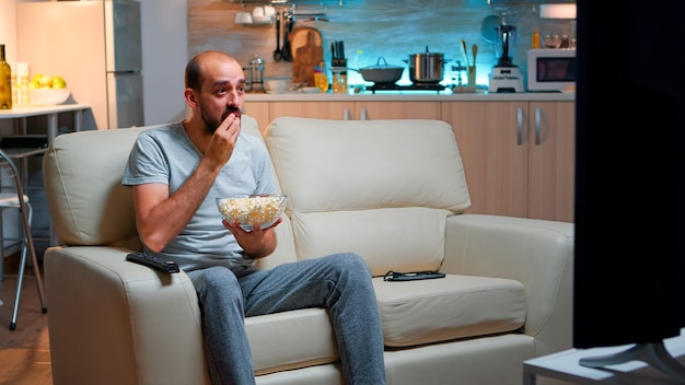 Sport football fan watching game late at night