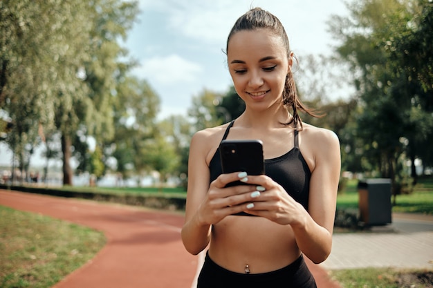 Sport girl. Young attractive girl goes in for sports in the morning outdoors.