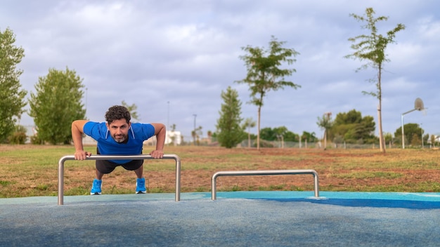 Sport man doing exercise push up Caucasian person workout at park Calisthenics