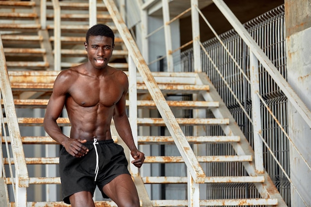 Sport Motivation Black Male Athlete Running Up On Urban Stairs Outdoors Enjoying Morning Workout With Free Space