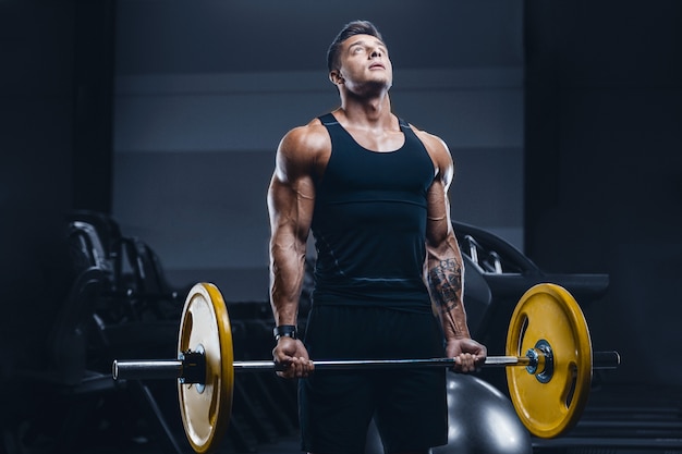 Sport muscular fitness man working out at the gym