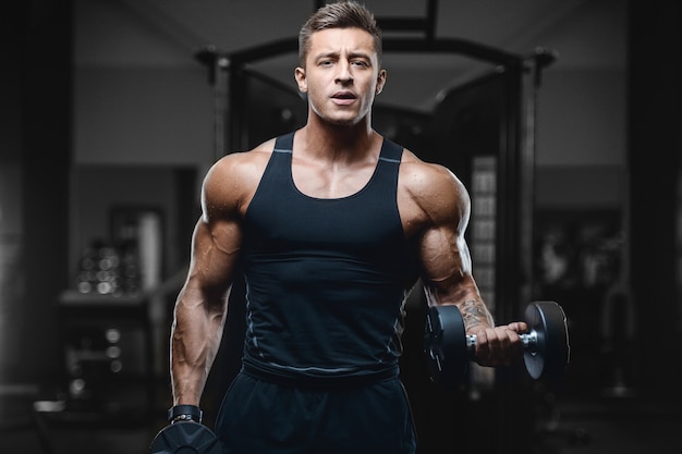 Sport muscular fitness man working out at the gym