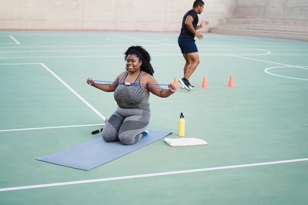 Sport people doing workout routine outdoor at city park  Focus on woman face