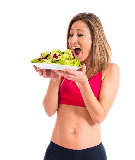 Sport woman holding a salad