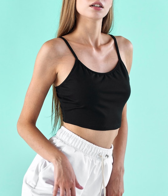 Sport woman stands in black sleeveless shirt fit girl isolated