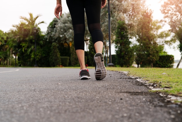 Sport woman walking towards on the road side