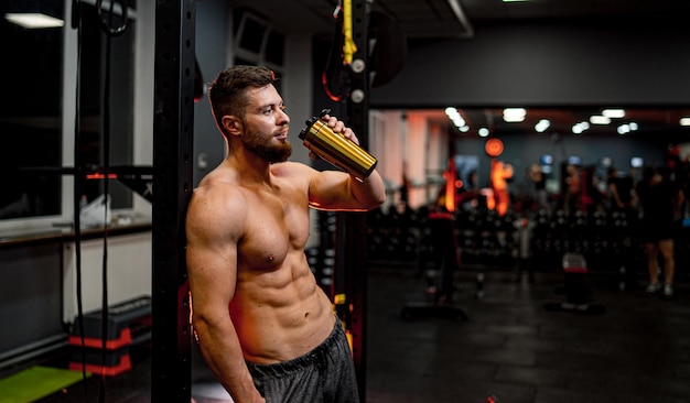 Sportive lifestyle athletic male Handsome young strong man standing in gym