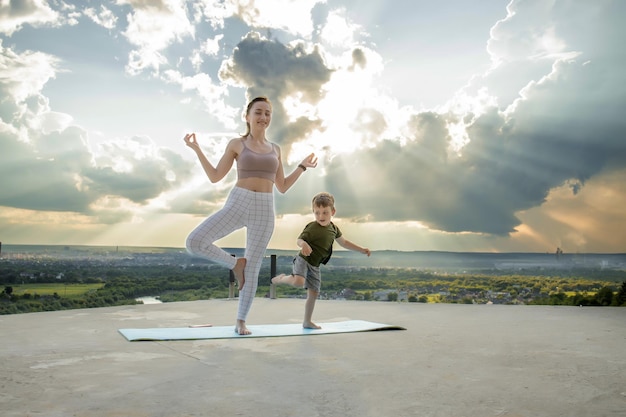 Sportive mother is doing workout with little son. Sports concept