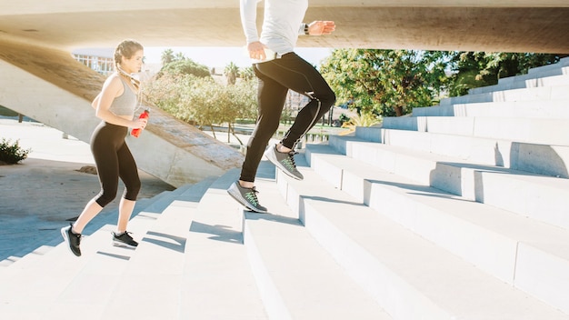 Sportive people running on stairs