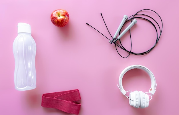 Sports equipment items on pink background flat lay