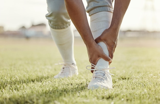 Sports field and man with ankle injury after game competition or baseball performance workout Emergency training accident or athlete legs in pain after fitness exercise or running on grass pitch