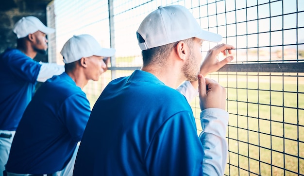 Sports focus and baseball with man in dugout for thinking training and planning strategy Relax teamwork and workout with group of people in park stadium for fitness competition match or coaching