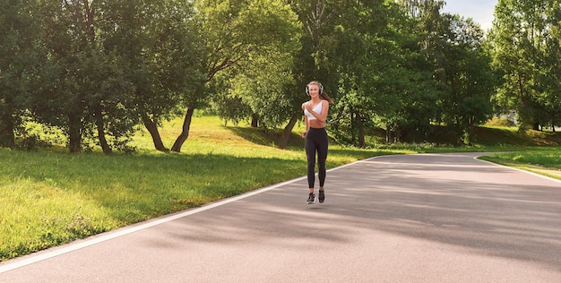 Sports girl jogging in the park The concept of a healthy lifestyle Sports Equipment Fitness style advertisement