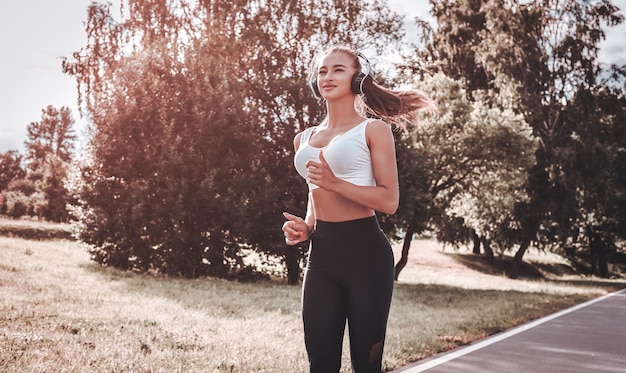 Sports girl jogging in the park The concept of a healthy lifestyle Sports Equipment Fitness style advertisement