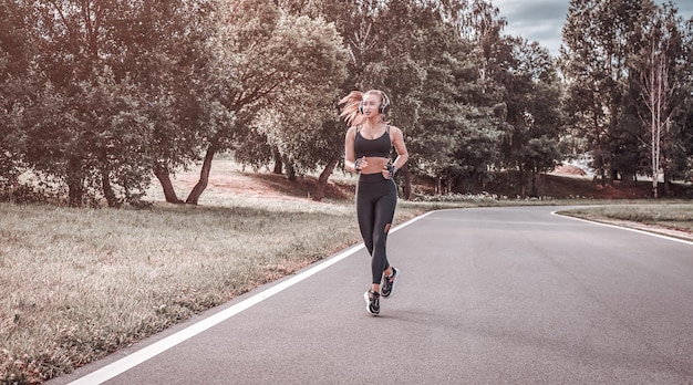 Sports girl jogging in the park The concept of a healthy lifestyle Sports Equipment Fitness style advertisement