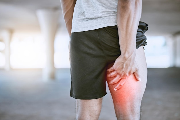 Sports man runner and thigh injury to hamstring muscle for fitness wellness and health person Running workout and exercise expert suffer medical leg pain after high performance training in city