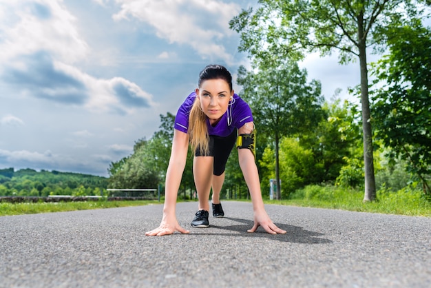 Sports outdoor - young woman doing fitness in park