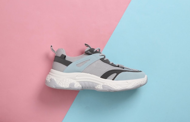 Sports sneaker on a bluepink pastel background