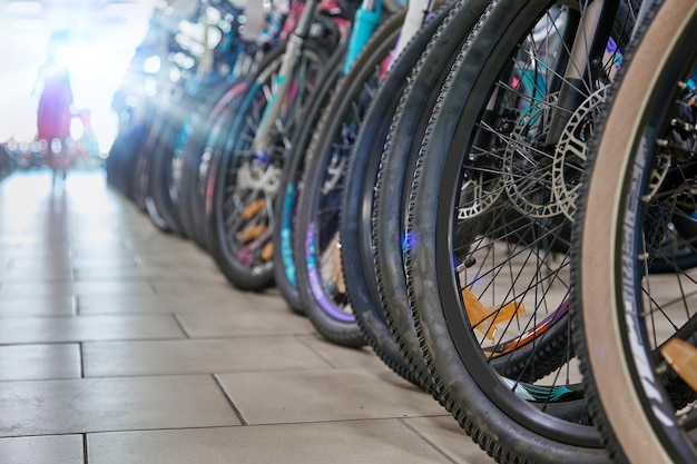 In sports store range of bicycles is lined up in a row for viewing by customers