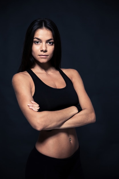 Sports young woman standing with arms folded