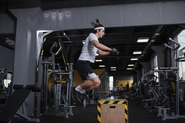 Sportsman doing box jumping workout