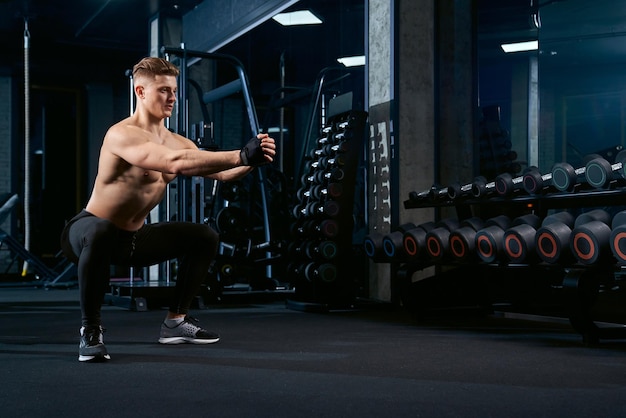 Sportsman doing squats in gym