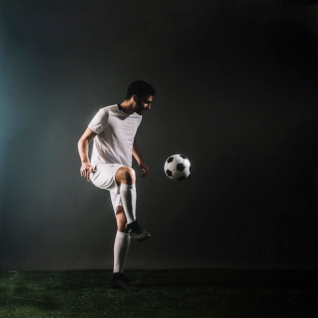 Sportsman juggling soccer ball