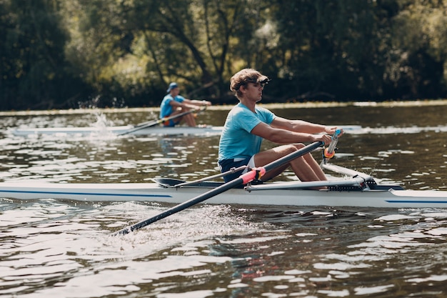 Sportsman single scull man rower prepare to competition boat regatta. Olympic games sport.