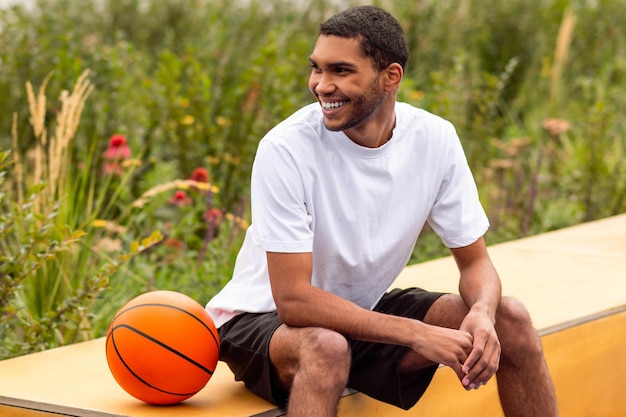 Sportsman sitting on a bench and resting after the game