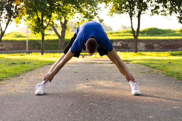 Sportsman stretching his body