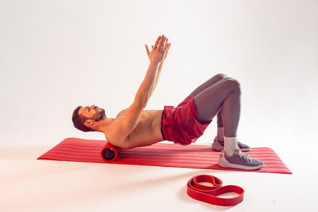 Sportsman train abdominal muscles on fitness mat