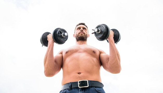 Sportsman with strong torso. Sport equipment. Fitness and bodybuilding sport. Sport lifestyle. Success is choice. Winning is habit. Dumbbell exercise gym. Muscular man exercising with dumbbell.