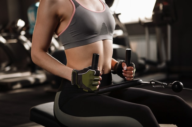 Sportswoman doing deadlift exercise at the gym