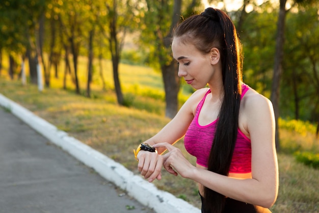 Sportwoman checking fitness and health tracking wearable device