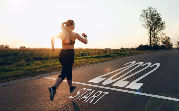 Sporty Girl waiting at the Starting line to Start the New Year 2022 New Goals Plans and Visions