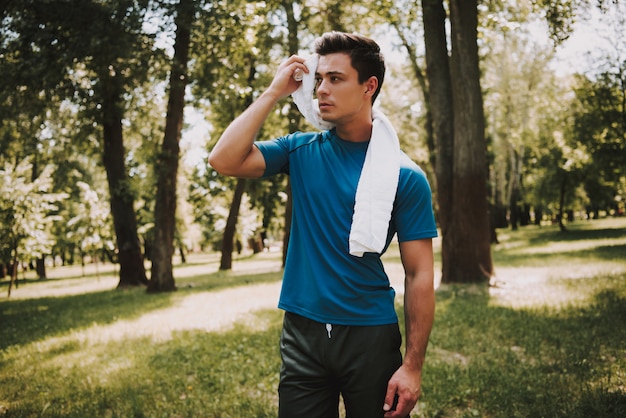 Sporty Man after Training in Green City Park