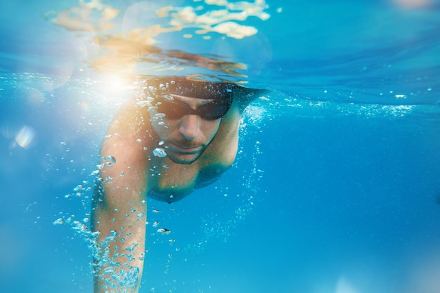 Sporty man swims fast in the sea