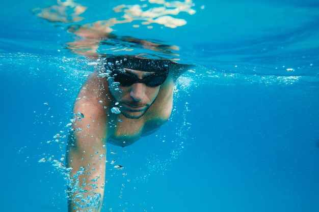 Sporty man swims fast in the sea