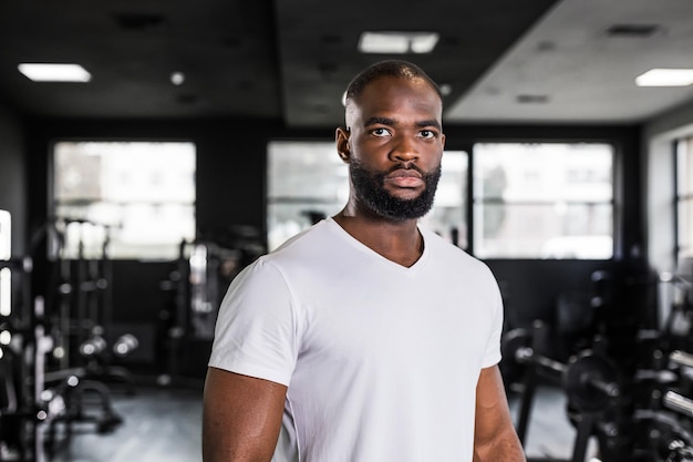 Sporty smiling african man resting having break after doing exercise